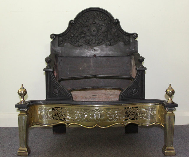 An iron and brass fire grate the