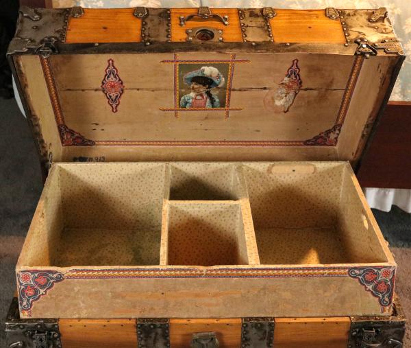 AN IRON MOUNTED WOOD SLAT TRAVEL