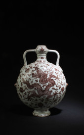 AN IRON RED PORCELAIN MOONFLAS