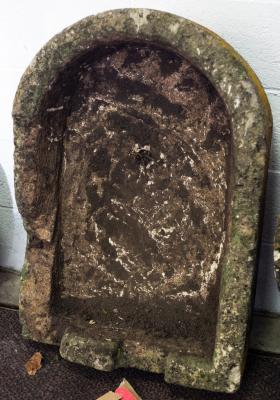 An irregular D-shaped stone trough,