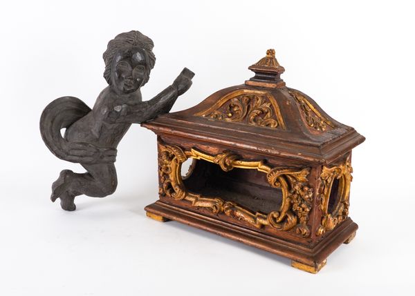 AN ITALIAN CARVED GILT AND RED MICA