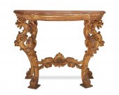 AN ITALIAN CARVED GILTWOOD CON