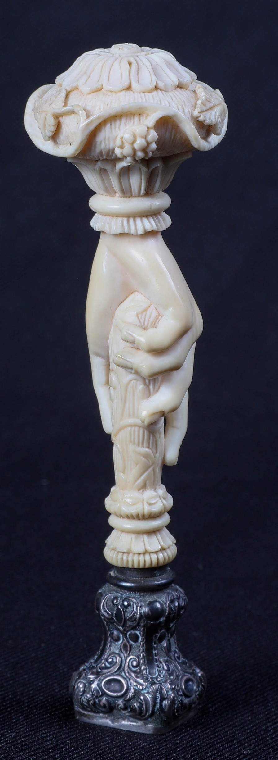 An ivory carved hand form seal, a