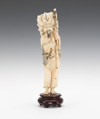 An Ivory Figure of a Fisherman A
