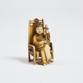 An Ivory Netsuke of a Seated F