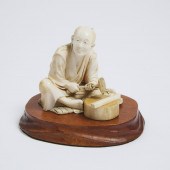 An Ivory Okimono of a Craftsma