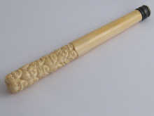 An ivory parasol handle carved with