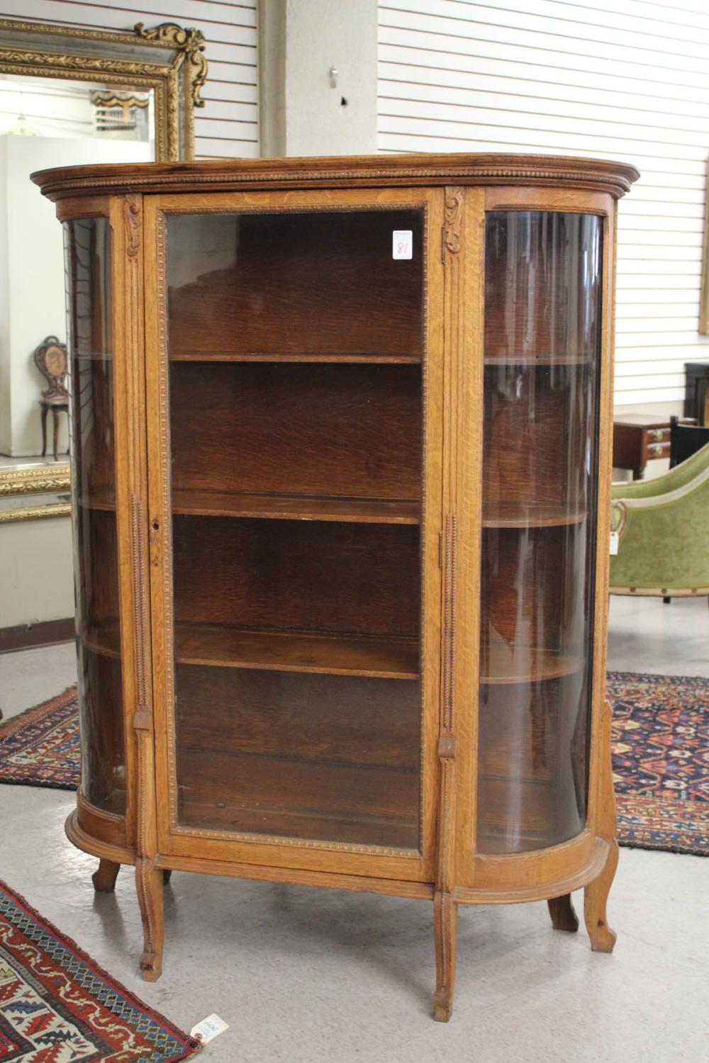 AN OAK AND CURVED GLASS CHINA