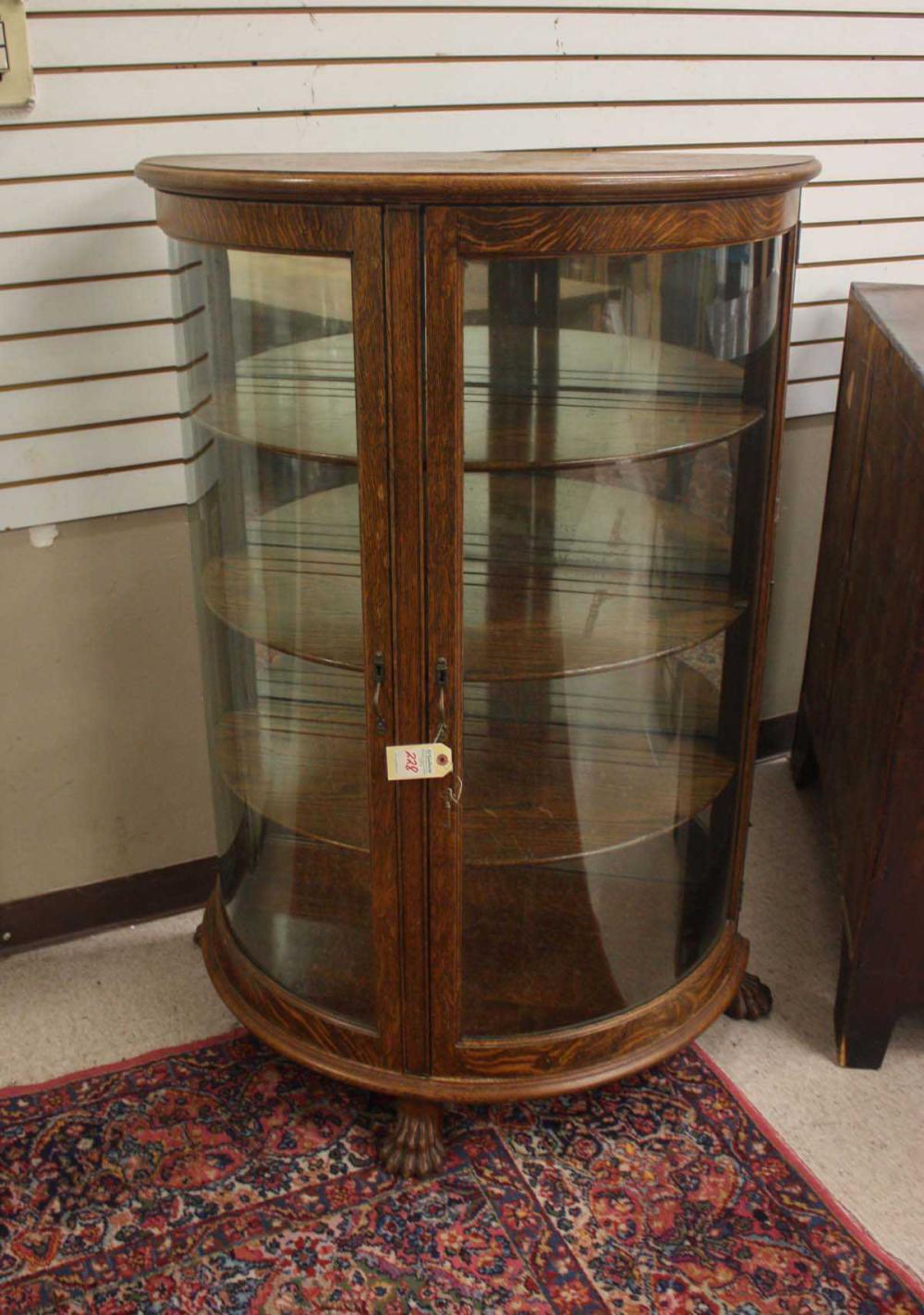 AN OAK AND CURVED GLASS DEMILUNE