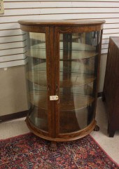 AN OAK AND CURVED GLASS DEMILU