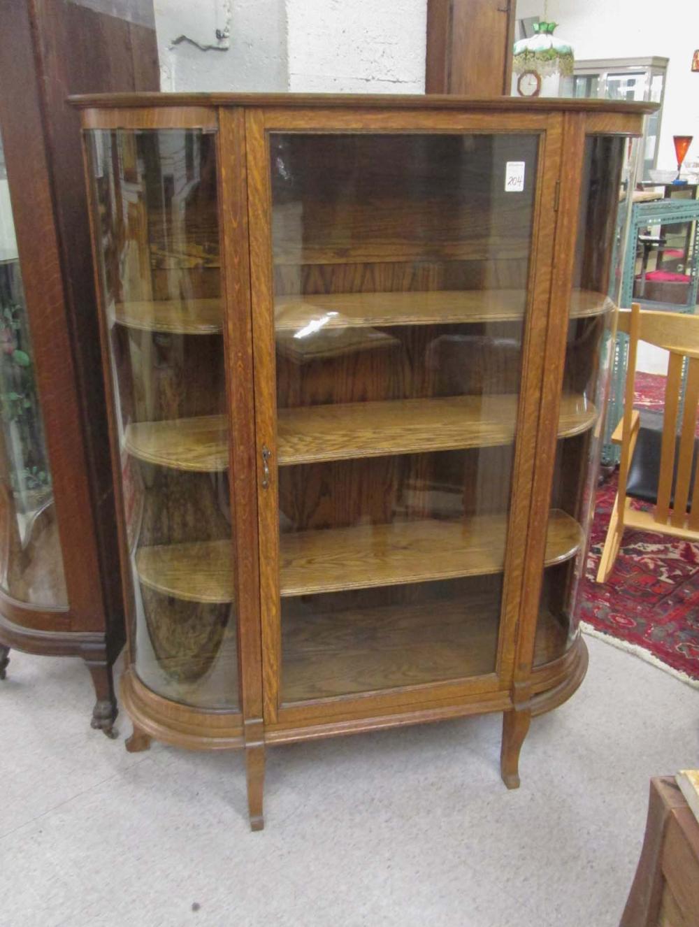 AN OAK AND CURVED GLASS CHINA