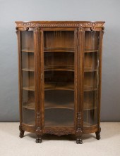 AN OAK AND CURVED GLASS CORNER