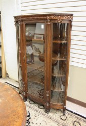 AN OAK AND CURVED GLASS CORNER