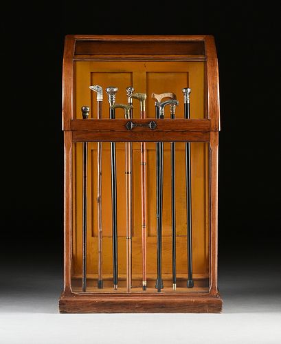 AN OAK AND GLASS CANE DISPLAY CASE,