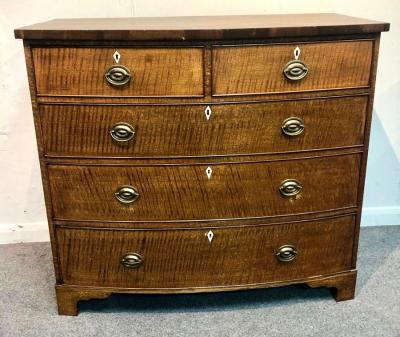 An oak bowfront chest of two