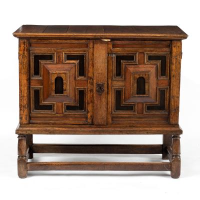 An oak cabinet on later stand, 17th