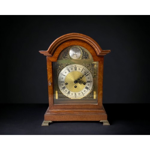 An Oak cased chiming mantel clock