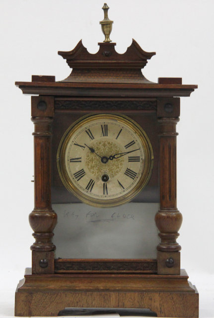 An oak cased mantel clock of
