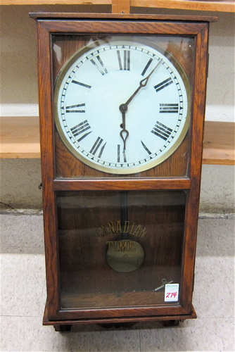AN OAK CASED WALL CLOCK The