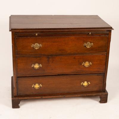 An oak chest of three long drawers,