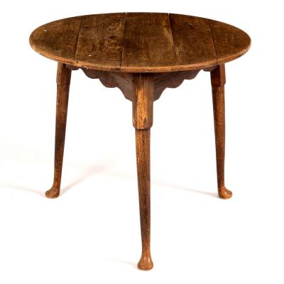 An oak cricket table raised on