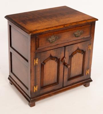 An oak cupboard fitted a drawer,
