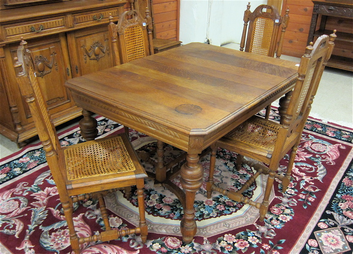 AN OAK DINING TABLE AND SIX