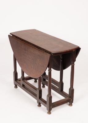 An oak drop leaf table on turned
