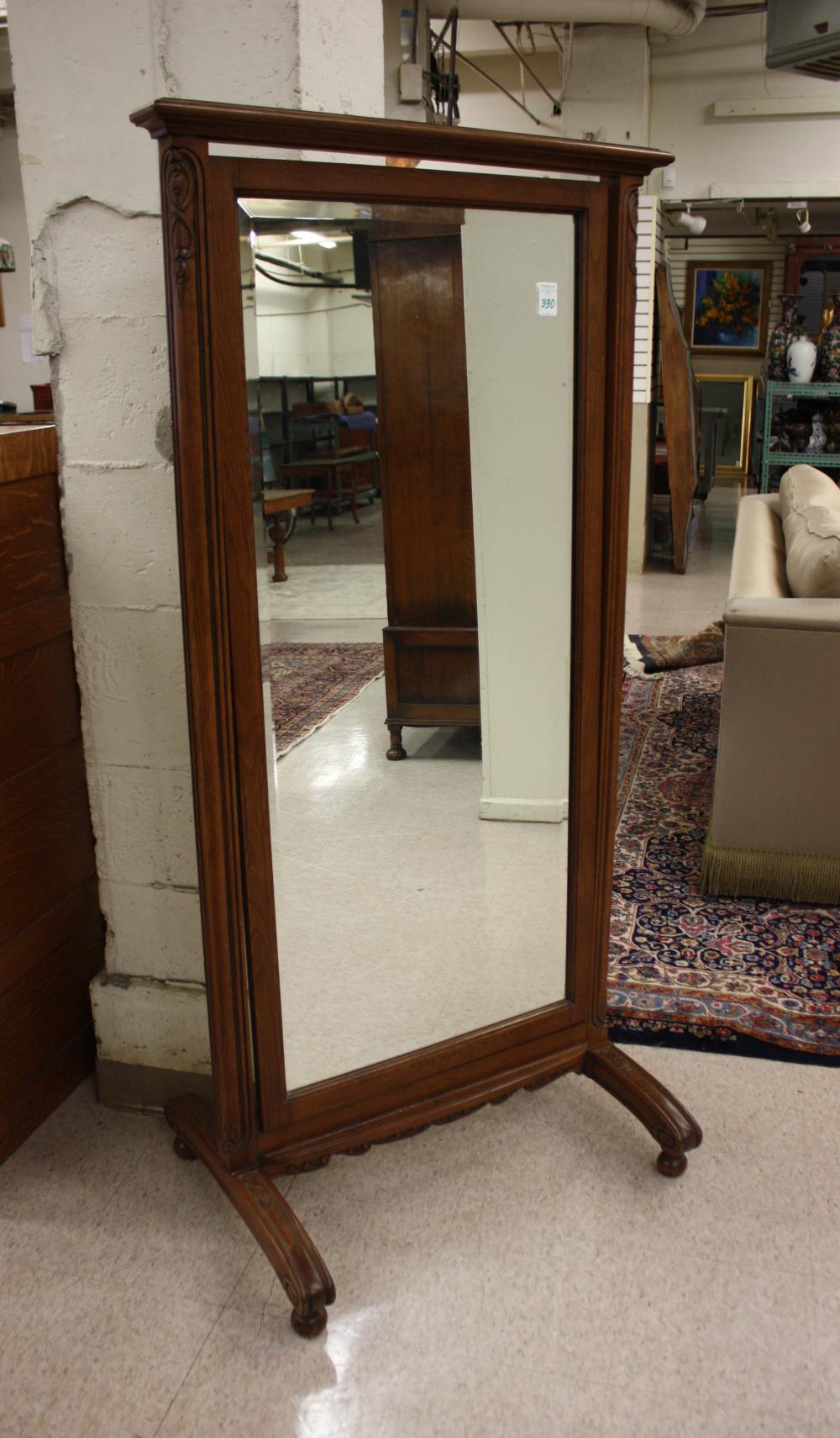AN OAK FRAMED CHEVAL MIRROR,