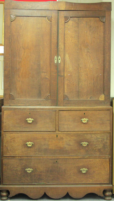 An oak linen press the top fitted