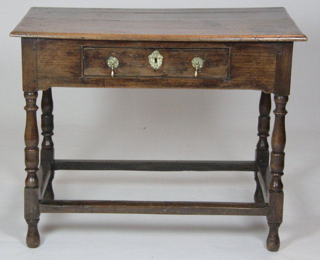 An oak one-drawer side table on