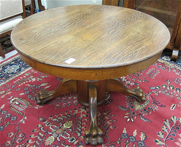 AN OAK PEDESTAL DINING TABLE WITH