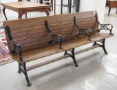AN OAK SLAT AND CAST IRON TRAI