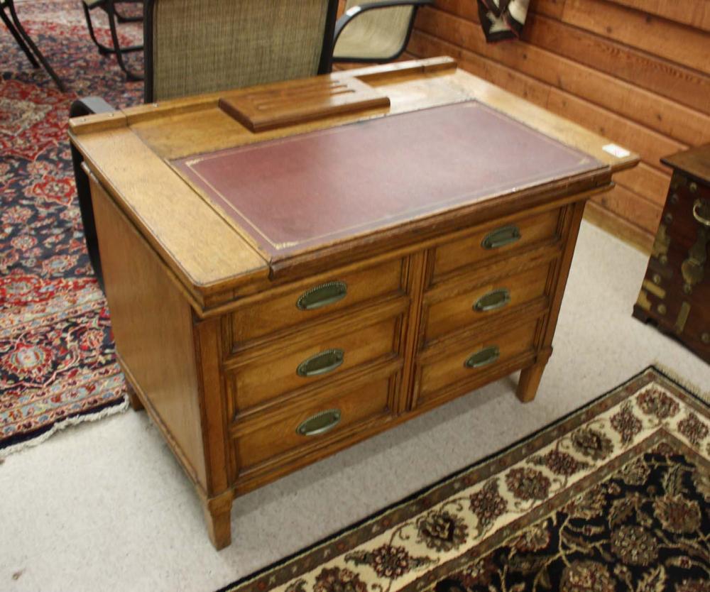AN OAK SLIDING-TOP WRITING DESK,