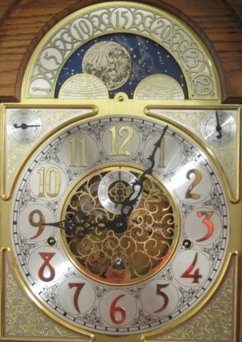 AN OAK TALL CASE FLOOR CLOCK