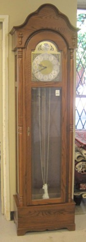 AN OAK TALL CASE FLOOR CLOCK