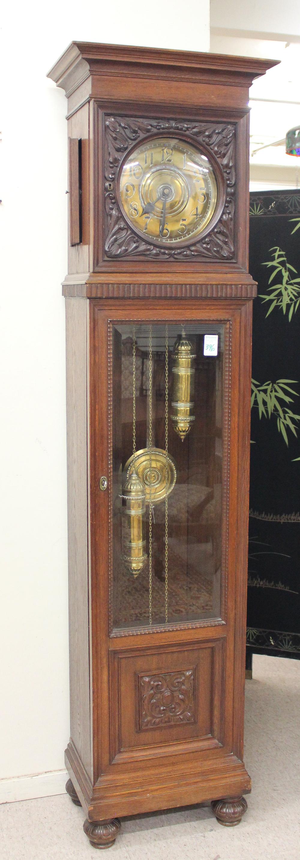 AN OAK TALL CASE FLOOR CLOCKAN