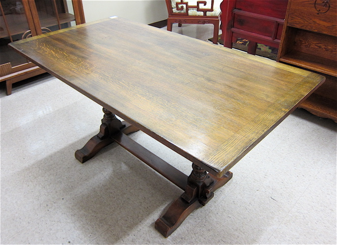 AN OAK TRESTLE DINING TABLE