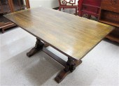 AN OAK TRESTLE DINING TABLE Eb