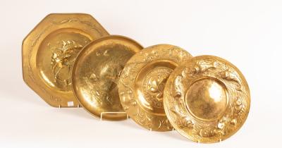 An octagonal embossed brass charger