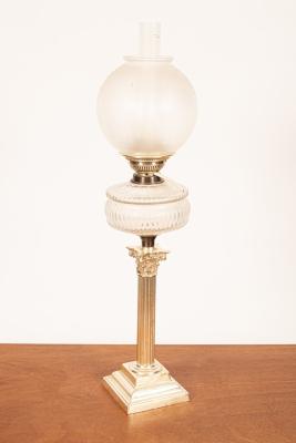 An oil lamp with etched glass shade