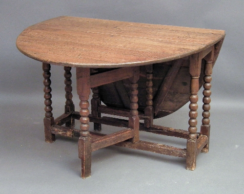 An old oak oval gateleg table on