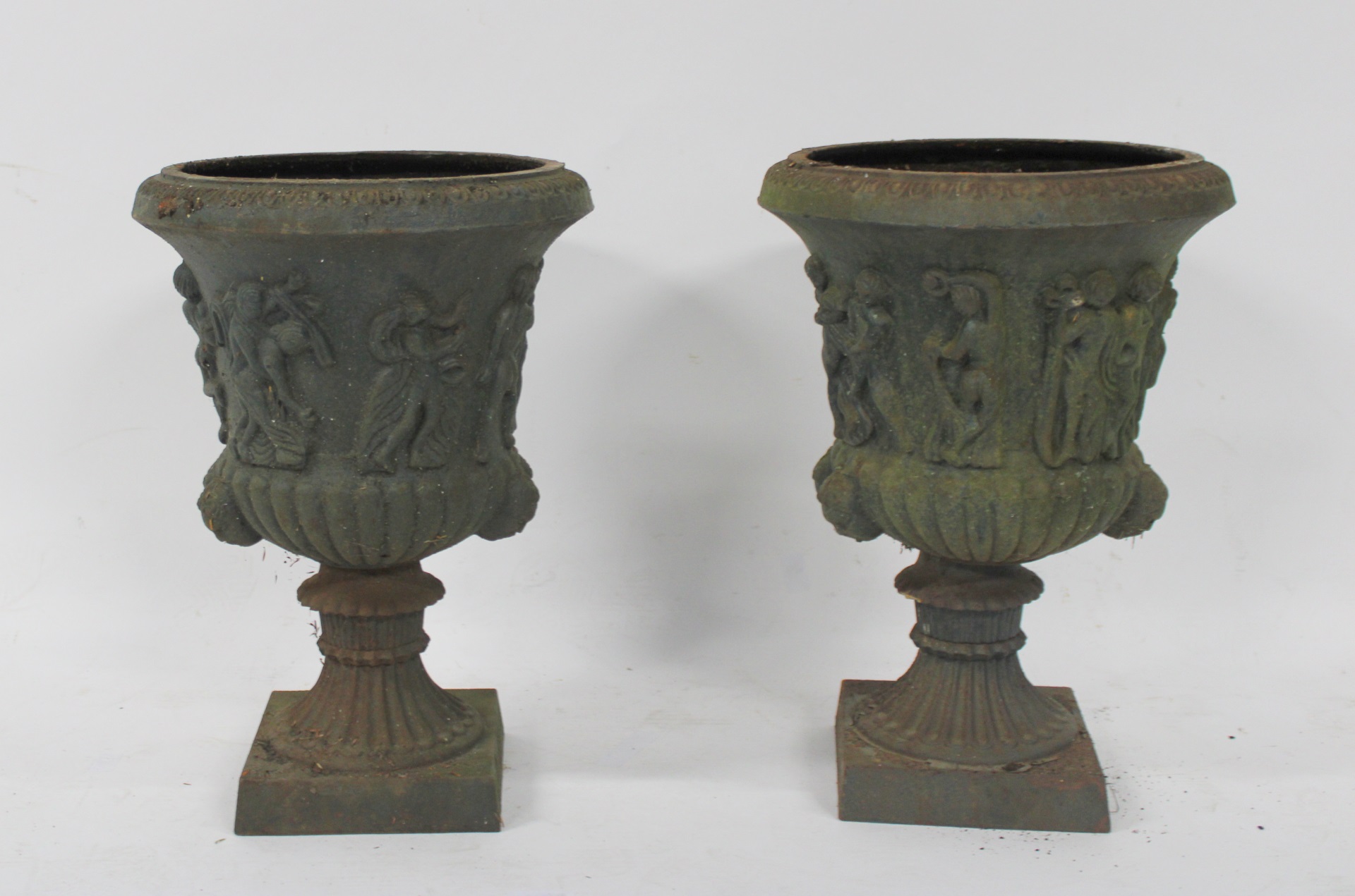 AN ORNATE PAIR OF PATINATED CAST