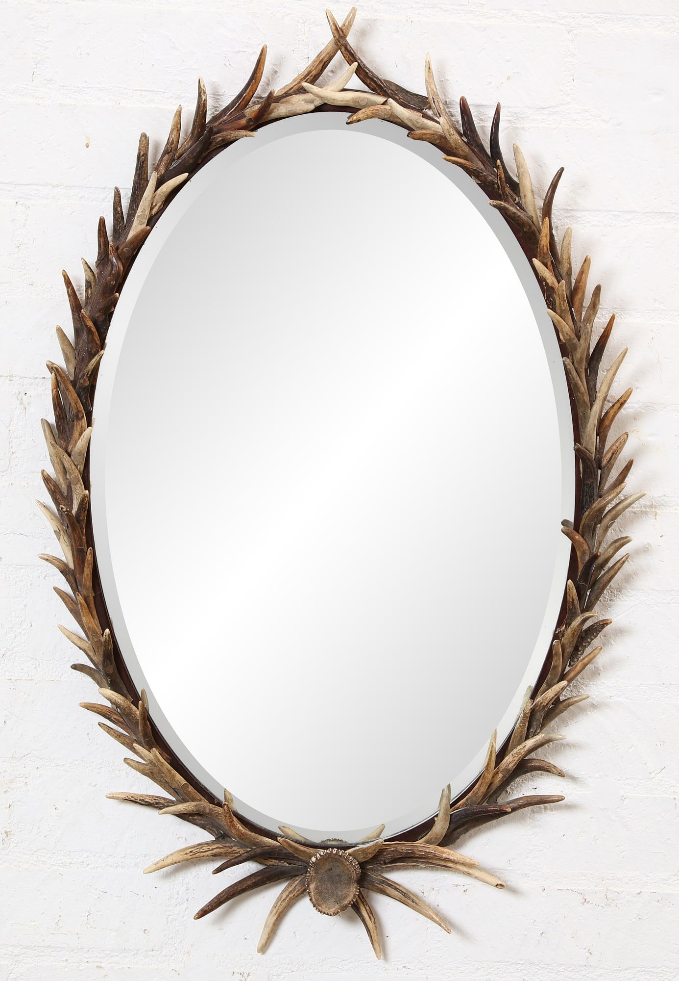 AN OVAL ANTLER FRAME MIRRORAn