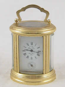 An oval brass French carriage clock