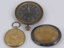 An oval brooch the stone set in