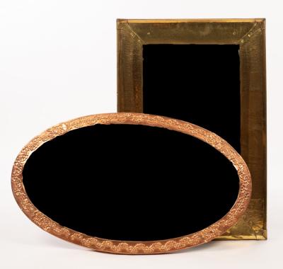 An oval copper framed mirror,
