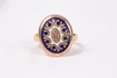 An oval gold coloured and enam