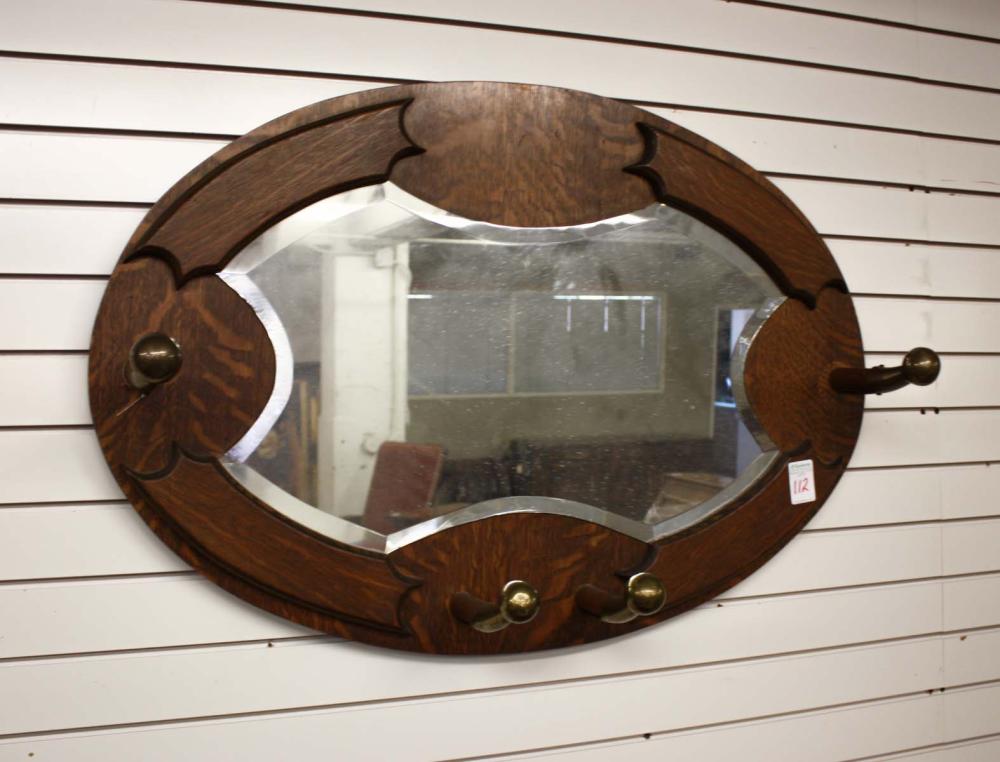 AN OVAL OAK-FRAMED GARMENT RACK