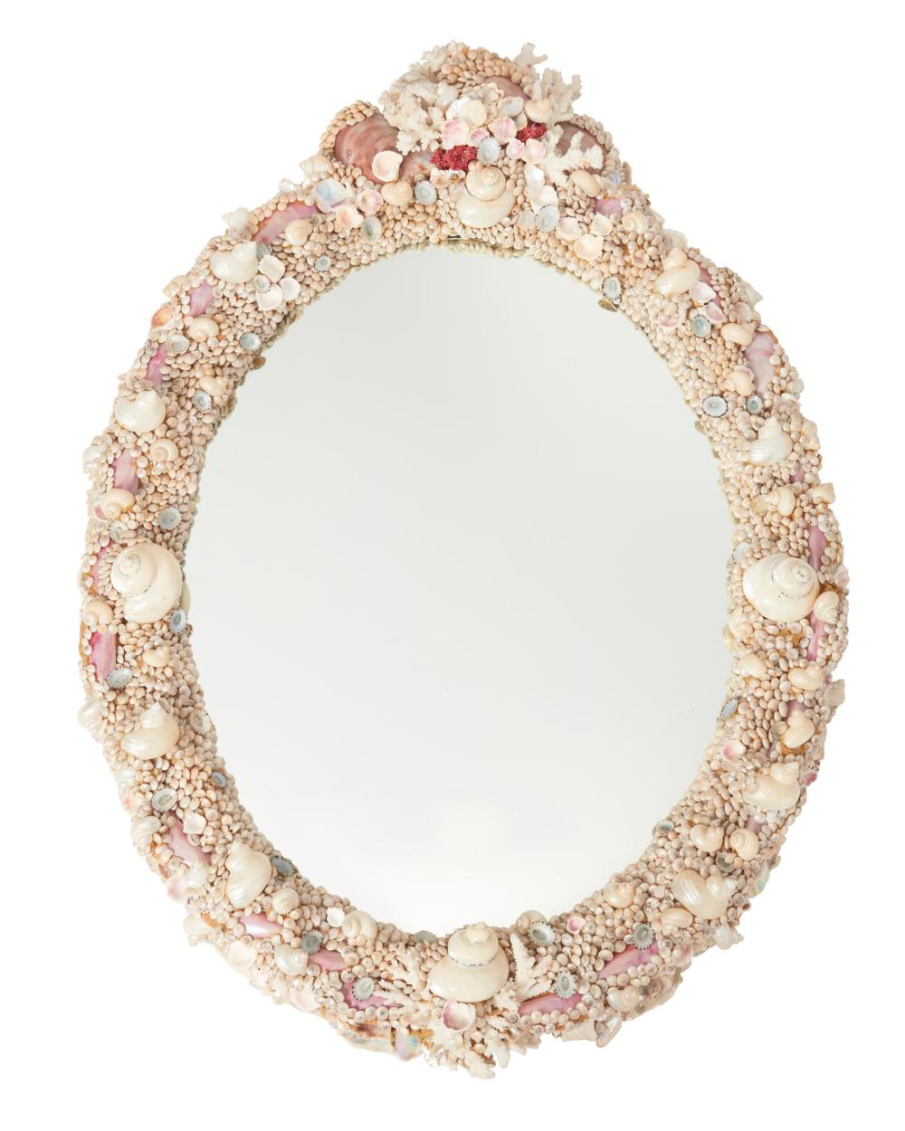 AN OVAL SHELL WALL MIRRORAn oval